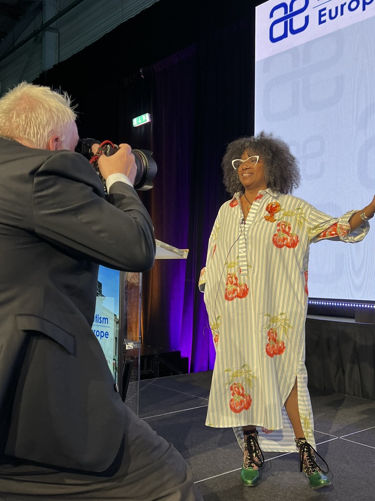 Dr. TC Waisman speaking on stage at Autism Europe